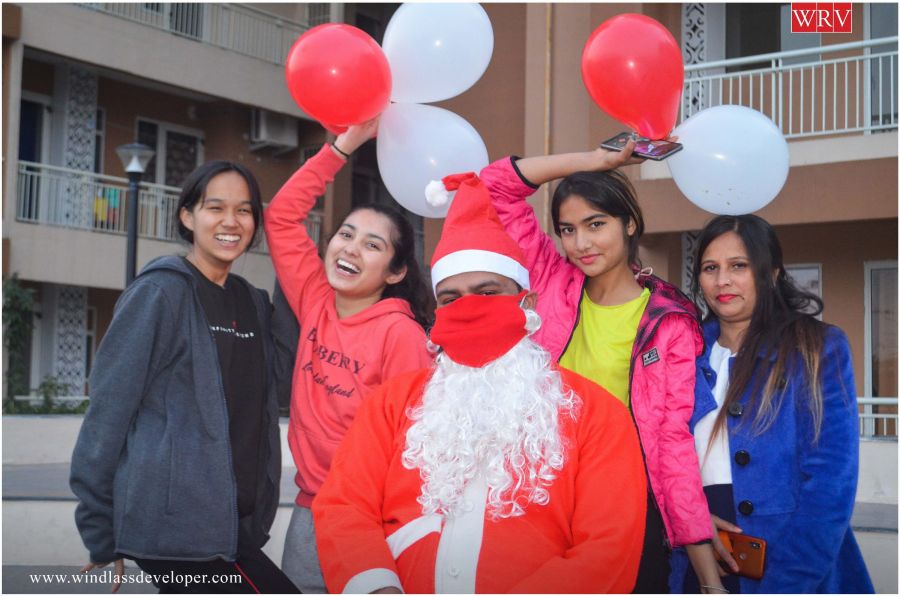 Residents with Santa and red balloons at the River Valley Christmas celebration