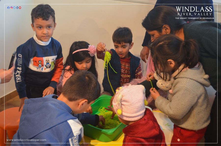 Young children playing with sensory craft materials at a River Valley kids’ event