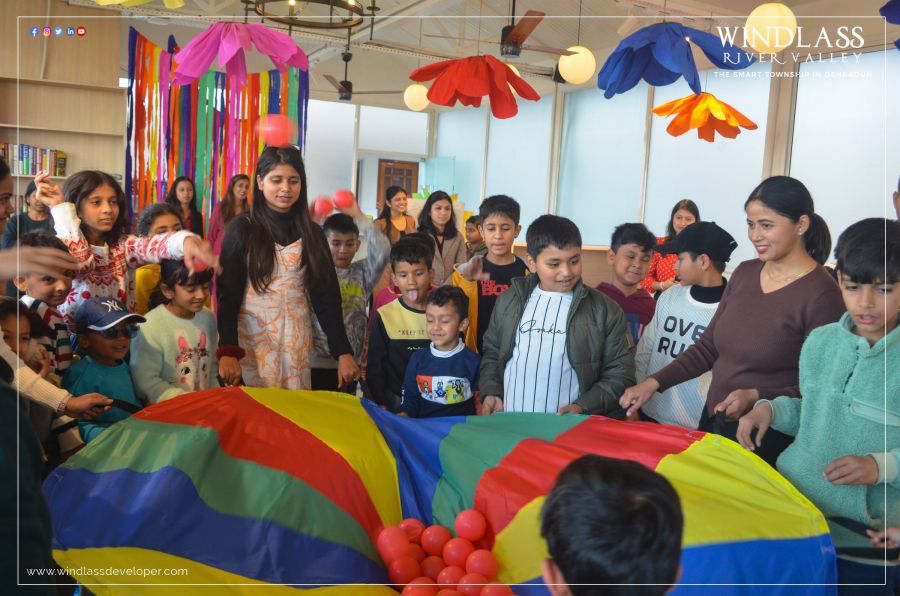 Children playing a parachute game at a River Valley kids’ event