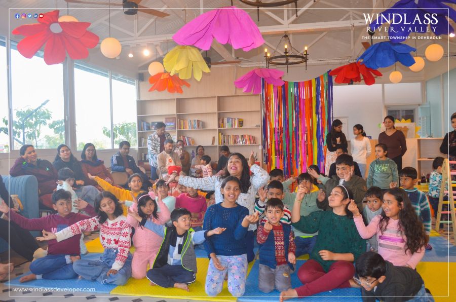 Children at a party under paper flower decorations in the River Valley clubhouse