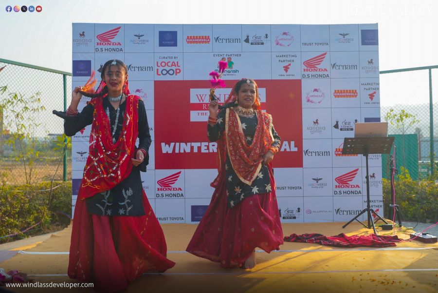 Performers in traditional dress dancing on stage at the River Valley Winter Carnival 2025