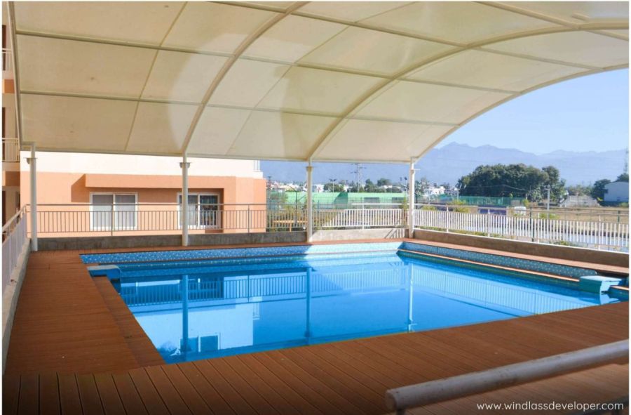 Covered swimming pool with a wooden deck at River Valley Township