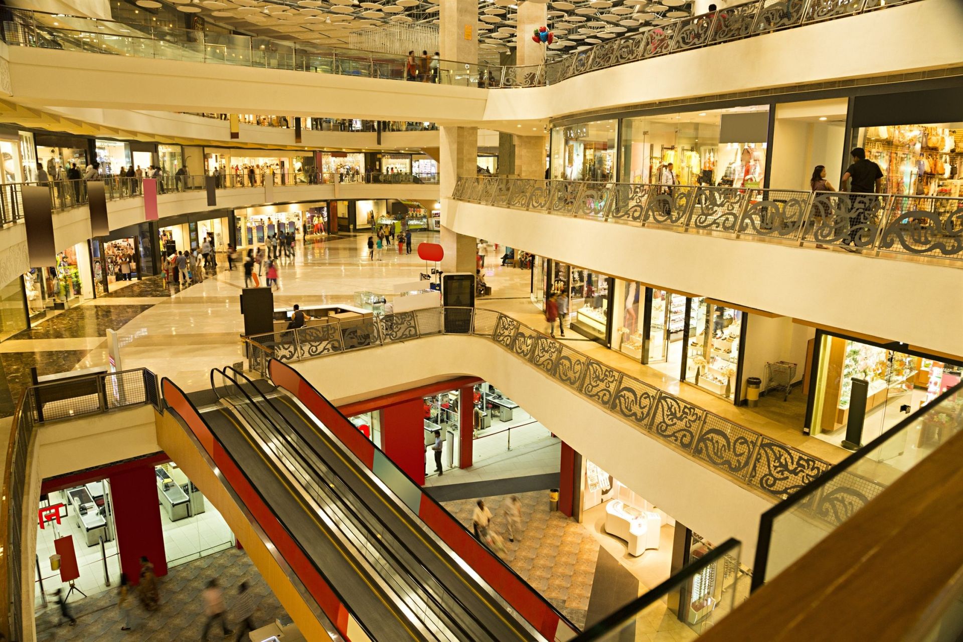 Shoppers on the escalators and balconies of a multi-level shopping mall